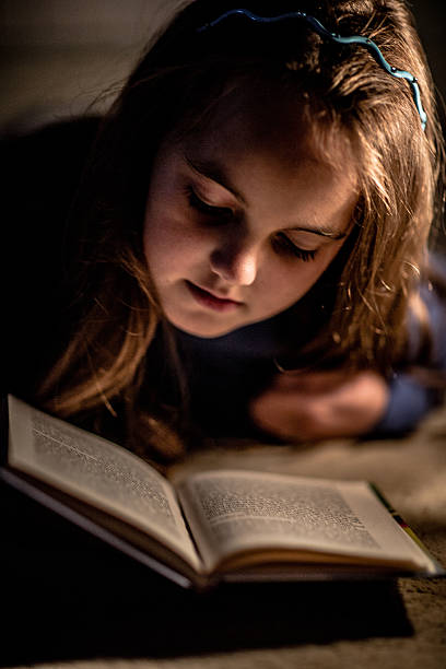 istock Girl reading book in lighting lamp 490780918