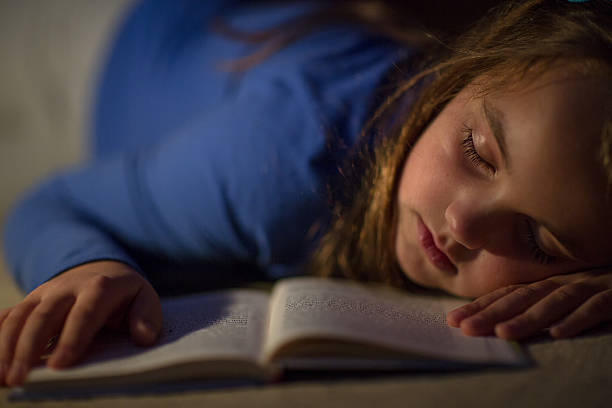 istock Girl reading book in lighting lamp 490782550