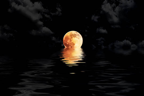 dark red full moon in cloud with water reflection dark red full moon in cloud with water reflection closeup showing the details of the lunar red full moon stock pictures, royalty-free photos & images