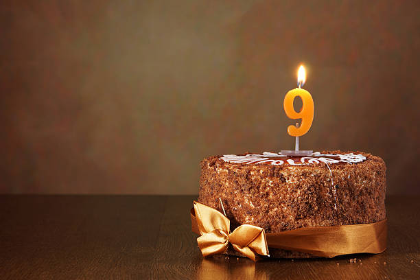 istock Birthday chocolate cake with burning candle as a number nine 490784170