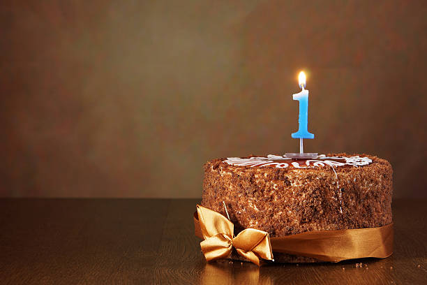 istock Birthday chocolate cake with burning candle as a number one 490784202