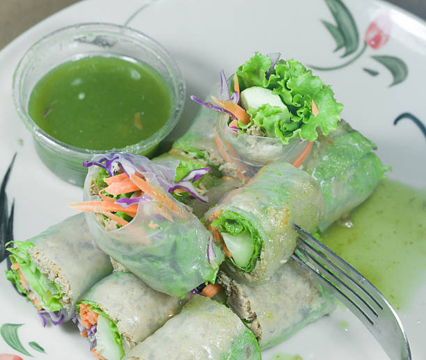 istock Portion of spring rolls on old wood with spicy sauce 490785658