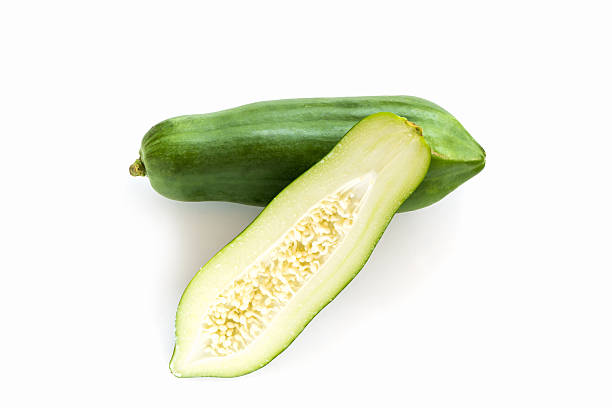 Half cut and whole green papaya.