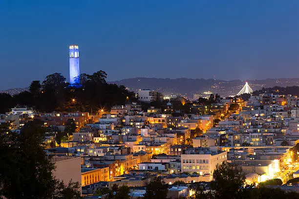 Coit tower and houses on Telegraph Hill in San Francisco at night