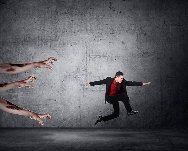 istock Business man running with zombie 490796528