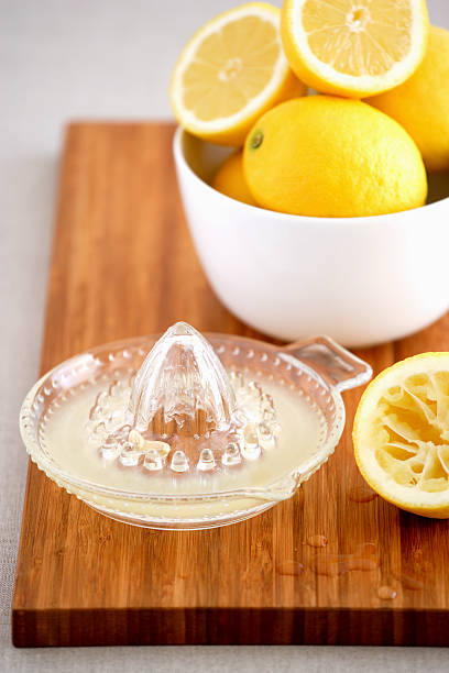 istock Bowl of lemons and juicer on cutting board 490799989