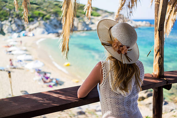 istock Back view of a woman looking at beach from above. 490800720