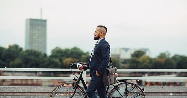 istock Businessman Pushing Bicycle and going home late. 490801240