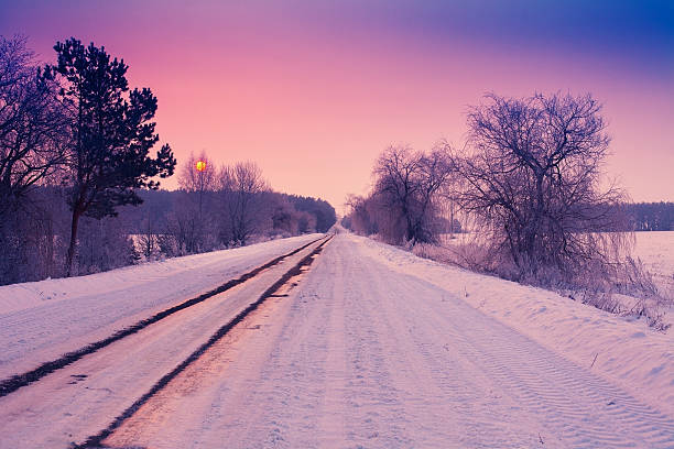 istock Sunrise over snowy road 490801246