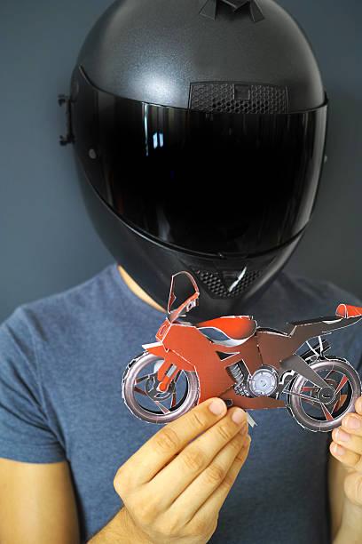 istock Man Wearing Black Helmet Holding A Red Motorcycle Toy 490802160
