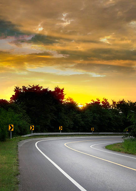 istock Asphalt road in forest with sunrise sky 490812288