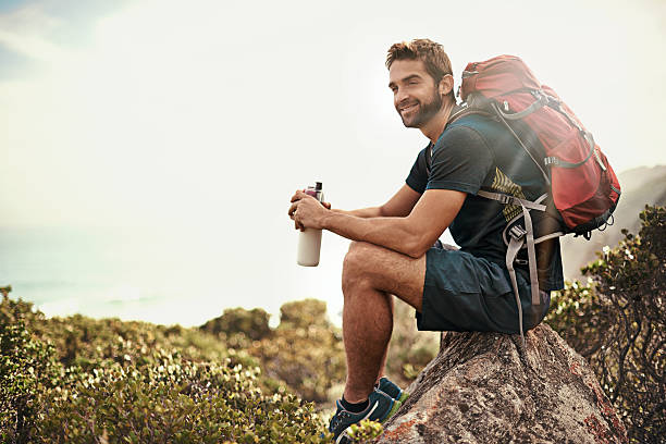 The perfect day to be out in nature... Shot of a young man taking a water break while out hikinghttp://195.154.178.81/DATA/i_collage/pi/shoots/784135.jpg weekend trip stock pictures, royalty-free photos & images