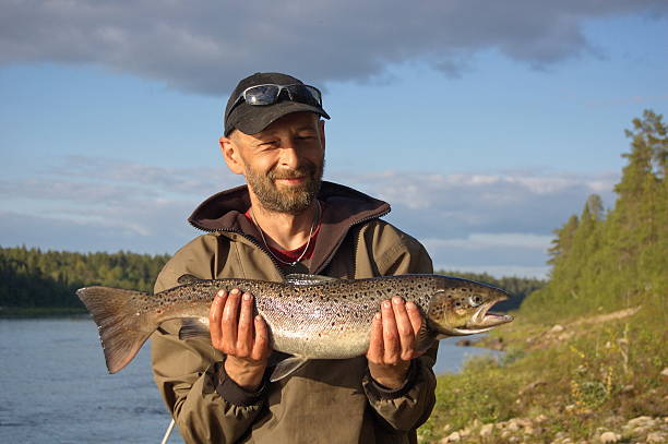 istock Fisherman caught a big salmon. 490817710