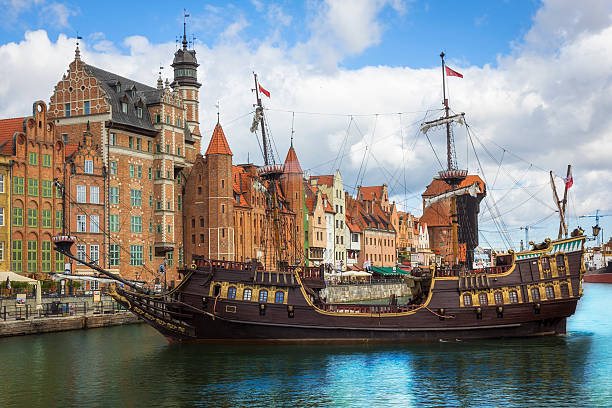 Old Town in Gdansk, Poland The classic view of Gdansk Old Town with the Hanseatic-style buildings and tourist boat transports tourists across the River Motlawa to the Baltic Sea for a cruise, Poland  gdansk photos stock pictures, royalty-free photos & images