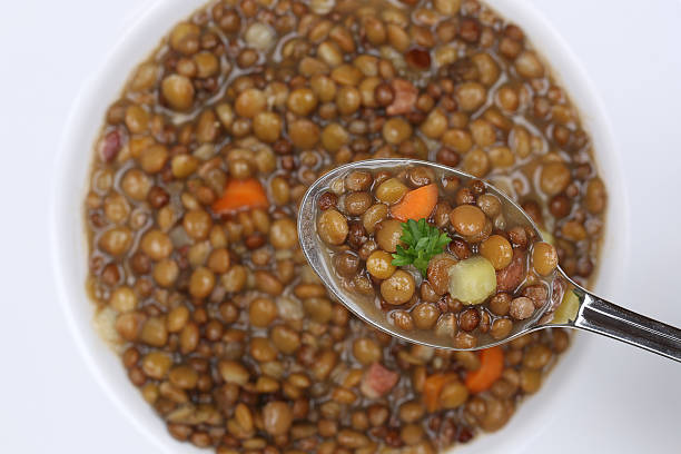 istock Eating lentil soup stew with lentils on spoon from above 490819880