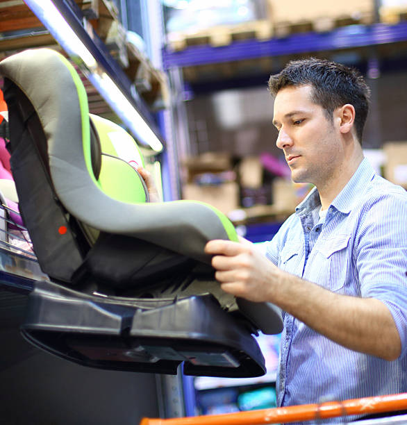istock Man buying car seat for his baby. 490819975