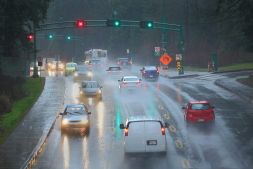 Commuter traffic through the Stanley Park Causeway during a heavy rain storm. Vancouver, BC., Canada.
