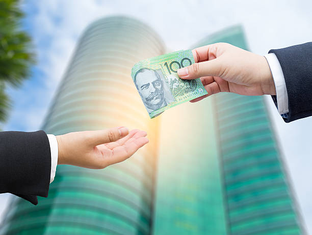 istock Hands of businessman passing Australian dollar (AUD). 490821128