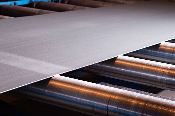 istock Continuous sheet of metallic material being fed through machine 490821393