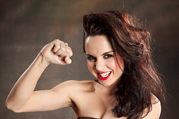 Strong confident girl flexing muscle