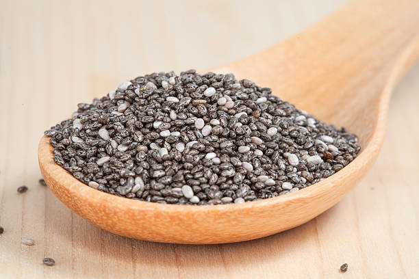 istock Nutritious chia seeds in  wooden spoon on wood table 490822536