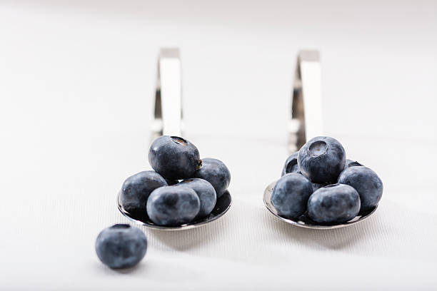 Blueberries on silver spoons stock photo