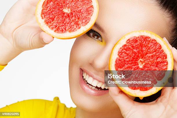 Young Brunette Woman With Grapefruit Stock Photo - Download Image Now - 18-19 Years, Adult, Adults Only