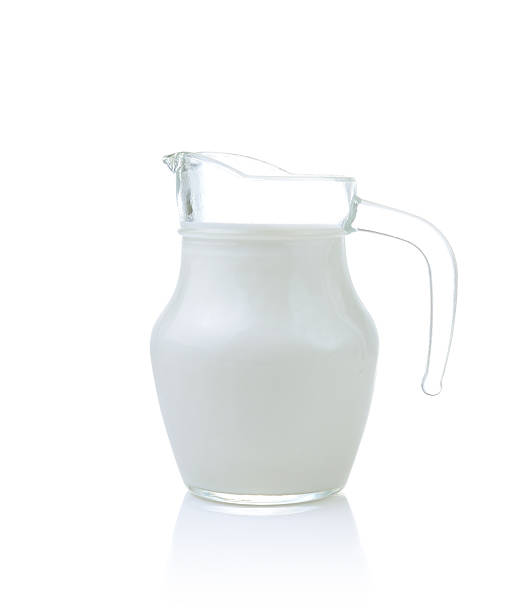 istock Glass jug of fresh milk isolated on white 490825714