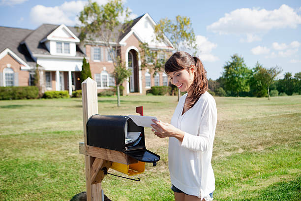 Picking up the mail Beautiful american housewife checking mail box mailbox photos stock pictures, royalty-free photos & images