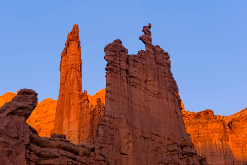 Fisher Towers Moab Utah.  Scenic view of iconic red rock canyon country.  Beautiful magic hour sunset light for saturated rich color.  Ancient Art rock formation.Converted from 14-bit RAW file.  ProPhoto RGB color space.