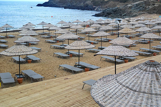 istock Sunbeds And Wood Umbrellas From Beach With Sea 490845652