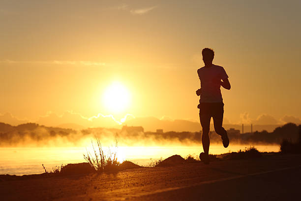 istock Silhouette of a man running at sunrise 490847544