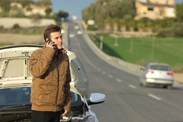 istock Happy man calling roadside assistance for his breakdown car 490847824