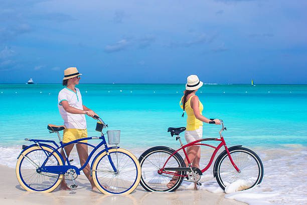 istock Young couple with bikes on white sandy beach 490848687