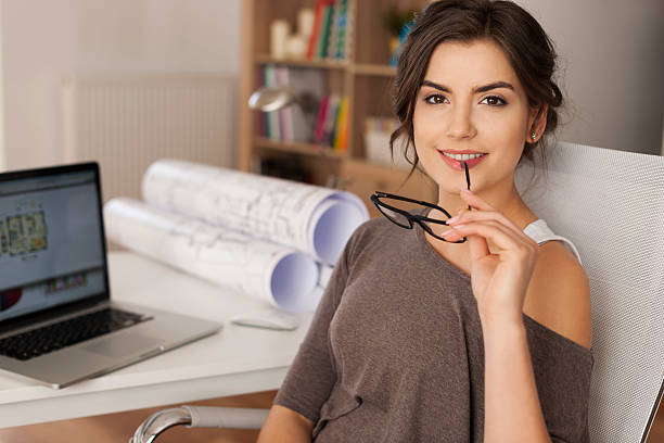 istock Smiling young woman architect in home office 490848935