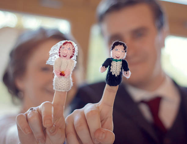 Married couple kidding with his and hers finger puppets.