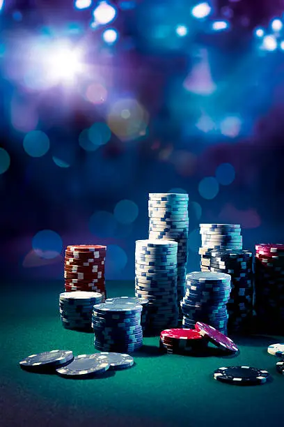 Photo of Casino chips with dramatic lighting and lens flares
