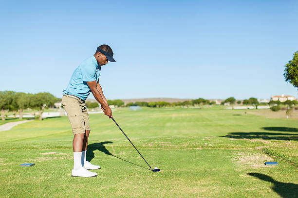 istock African golfer looking at the ball, ready to hit it. 490850209