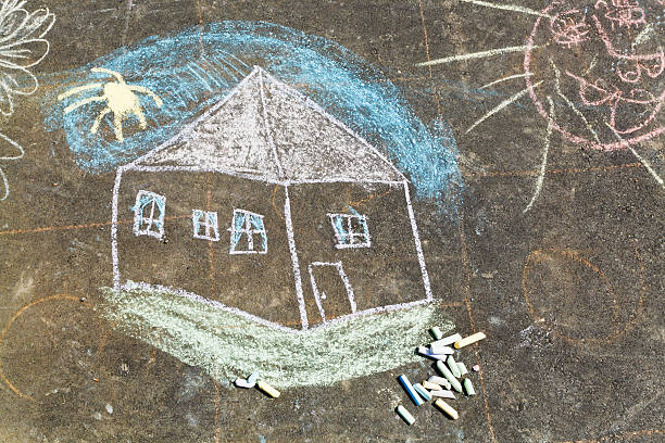 istock house and sun painted on asphalt by chalk 490850573