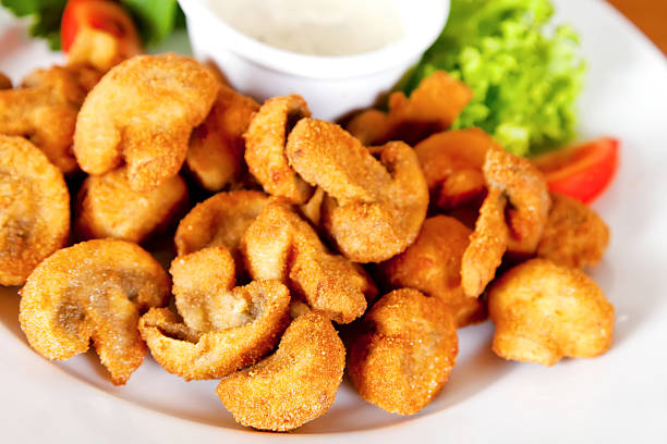 Deep-fried champignon mushrooms Deep-fried champignon mushrooms with lettuce, tomatoes and mayonnaise deep fried photos stock pictures, royalty-free photos & images