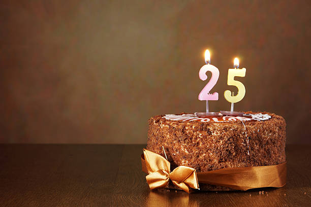 istock Birthday chocolate cake with burning candles as number twenty five 490851536