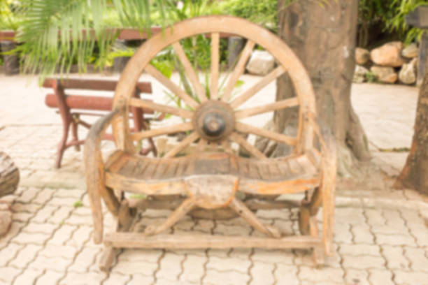 In public parks, long wooden chairs are often built around large trees for visitors to sit and eat in a natural setting.