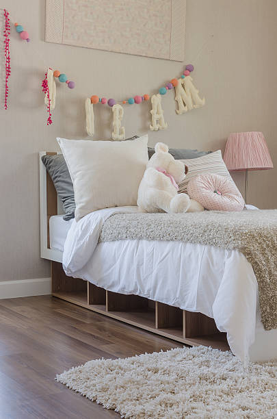 istock kid's bedroom with pillows and dolls on bed 490851882