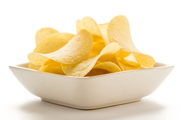 potato chips in a white bowl stock photo