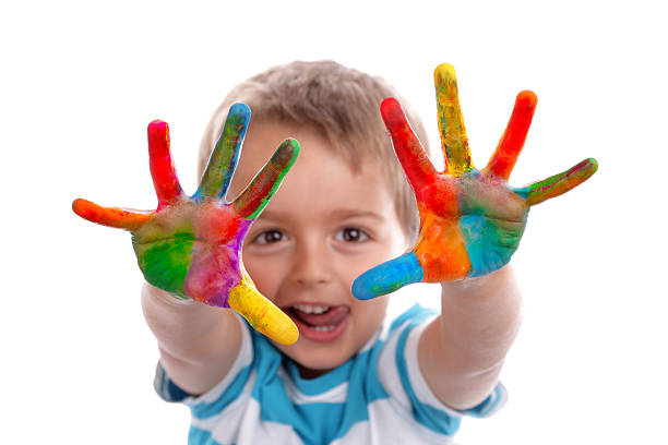 Creative education Boy with hands painted in colorful paints ready to make hand prints preschool student stock pictures, royalty-free photos & images