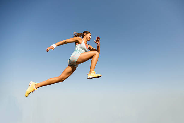 istock Young woman taking long jump 490858666