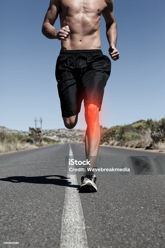 Highlighted knee of running man Digital composite of  Highlighted knee of running man Exercising Stock Photo