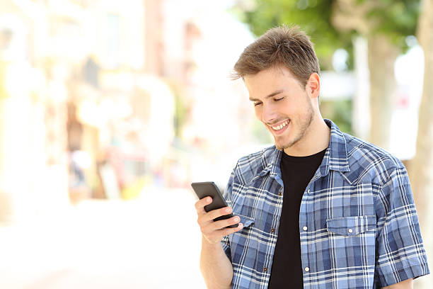 istock Young casual man using a smart phone in the street 490875642