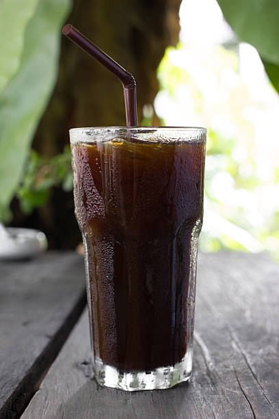 istock Ice black coffee on wooden table 490876058