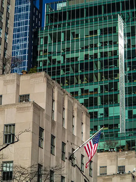 American flags on the building waving in the wind on Manhattan New York City on a sunny day